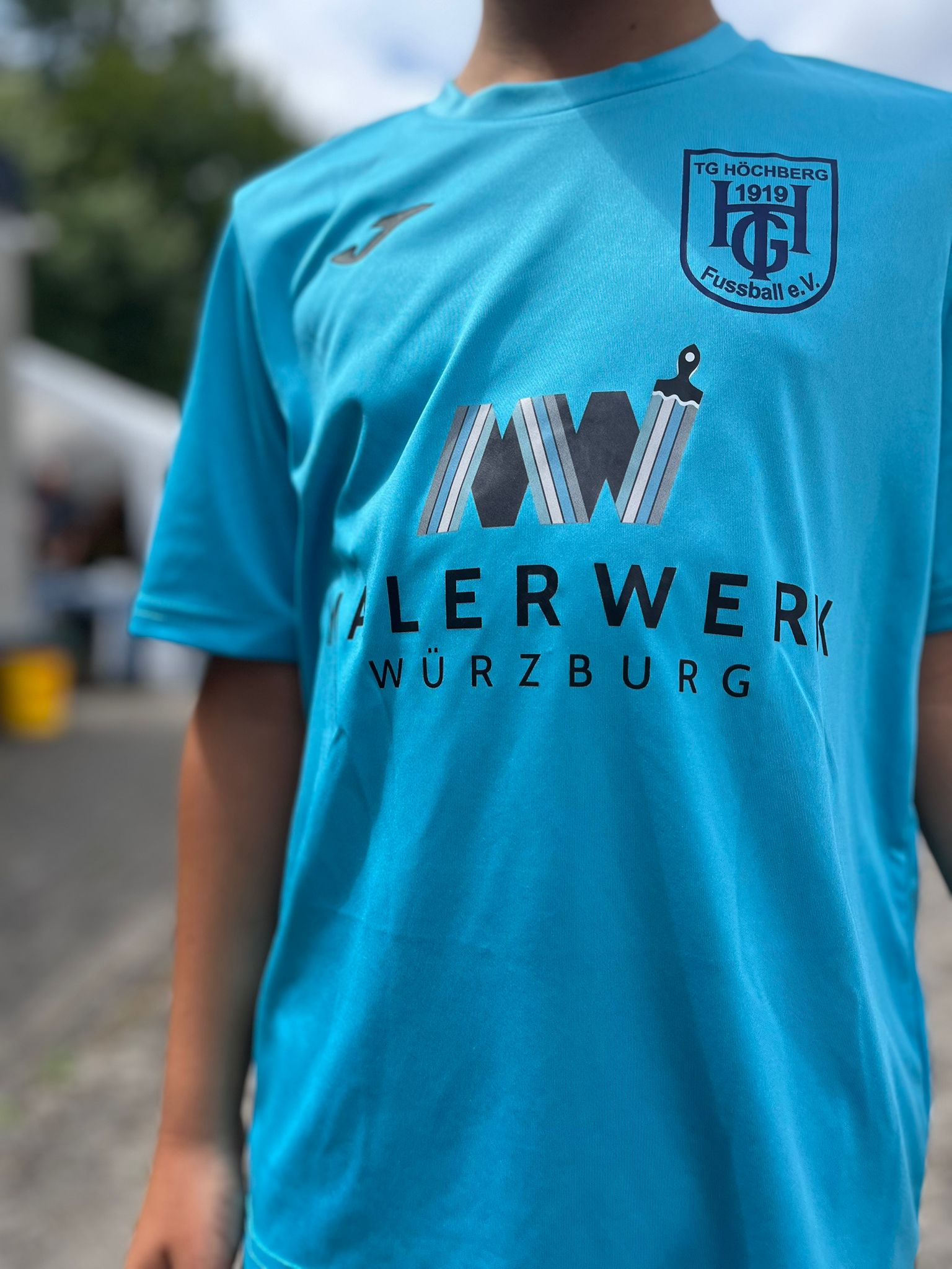 Trikot der U11 blau der TG Höchberg mit Malerwerk-Würzburg-Sponsoring-Schriftzug